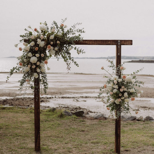 Floral archway with a coastal background